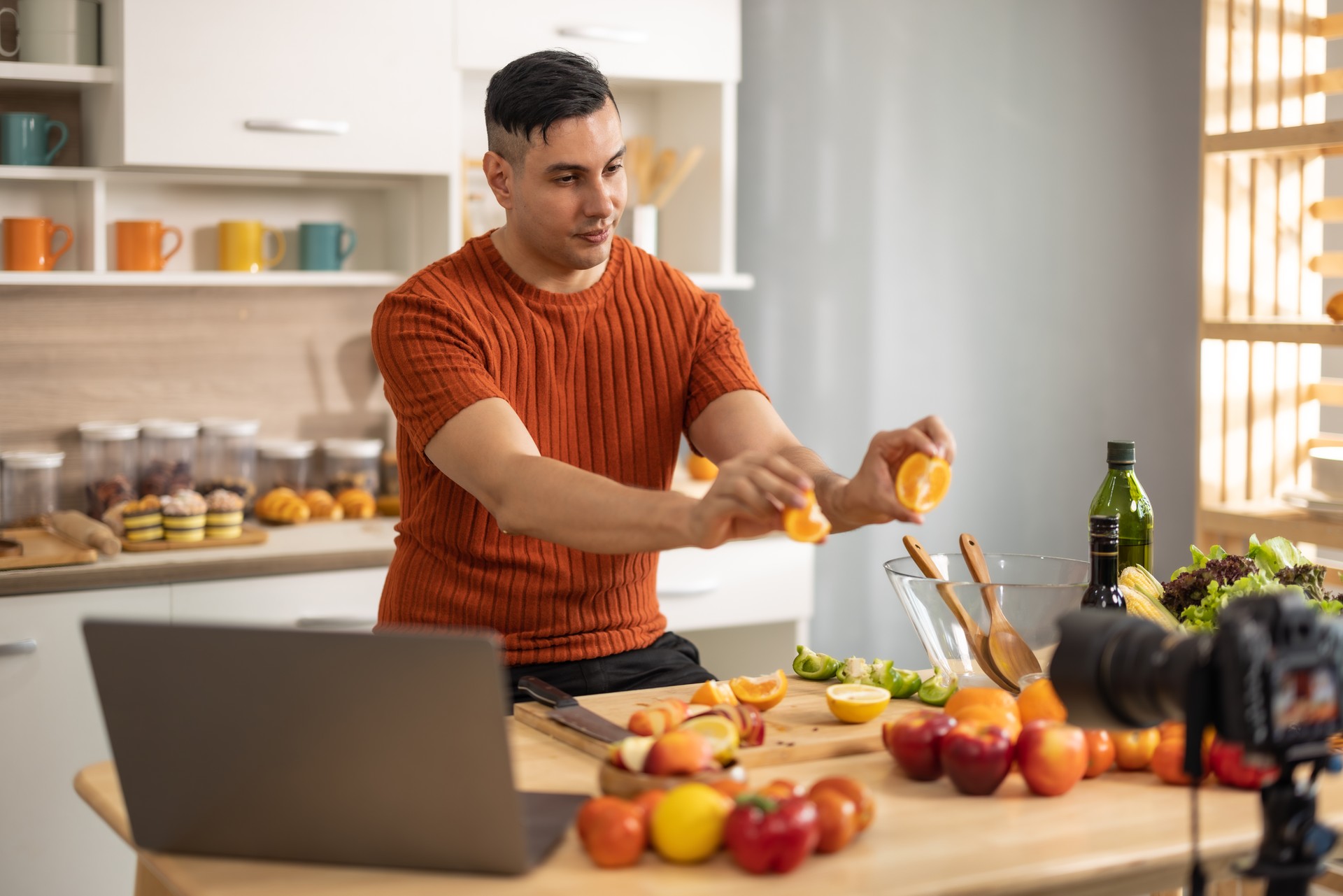 A male social media influencer creates videos, shares instructions for making fruit salad online, expands his subscriber and advertising-generating audience. Start-up options for new small businesses